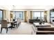 Spacious living room with large windows, city views, contemporary furniture, and a dining area at 1133 14Th St # 4150, Denver, CO 80202