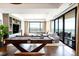 Beautiful living room with a pool table, built-in shelving, and expansive windows showcasing city views at 1133 14Th St # 4150, Denver, CO 80202