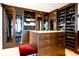 Spacious walk-in closet with custom built-ins, drawers, and glass door cabinets provides ample storage at 1133 14Th St # 4150, Denver, CO 80202