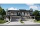 A beautifully designed two-story townhome featuring stone accents, a two-car garage, and a welcoming covered entrance at 6741 Arbor E Blvd, Thornton, CO 80602