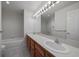 Bright bathroom featuring double sinks and a large mirror at 8181 S Saint Paul Way, Centennial, CO 80122