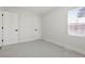 A bright bedroom features plush gray carpet, crisp white walls, and two white doors with black hardware at 1023 Hooker St, Denver, CO 80204
