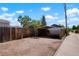 An open carport behind a wooden fence, providing covered parking on the property at 1023 Hooker St, Denver, CO 80204