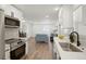 Modern kitchen with white cabinets, stainless steel appliances, and open view to the living area at 1023 Hooker St, Denver, CO 80204