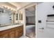 Bathroom with a wooden vanity and a glimpse into the basement at 11676 Josephine Cir, Thornton, CO 80233