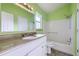 Bright bathroom with modern vanity, bathtub, and shower at 11676 Josephine Cir, Thornton, CO 80233