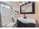 Cozy bathroom with modern fixtures, a shower-tub combo, and a dark vanity at 11676 Josephine Cir, Thornton, CO 80233