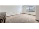 Neutral carpet bedroom with a large window providing natural light at 11676 Josephine Cir, Thornton, CO 80233