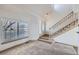 Bright entryway featuring carpeted floors, a staircase, and ample natural light at 11676 Josephine Cir, Thornton, CO 80233