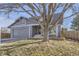 Charming gray two-story home with a well-maintained lawn and mature trees at 11676 Josephine Cir, Thornton, CO 80233