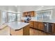 Well-lit kitchen with wood cabinets, stainless steel appliances, and an island at 11676 Josephine Cir, Thornton, CO 80233