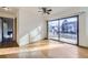 Sunlit living room with hardwood floors, a ceiling fan, and sliding glass doors at 11676 Josephine Cir, Thornton, CO 80233