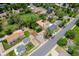 An aerial view showing a home with a spacious backyard, neighboring homes, and lush surroundings at 5573 S Huron St, Littleton, CO 80120