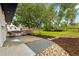 A landscaped backyard features a stone patio and seating area under mature trees at 5573 S Huron St, Littleton, CO 80120