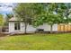 Well-manicured backyard with patio area, lush grass, and privacy fence at 5573 S Huron St, Littleton, CO 80120