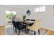 Bright dining room with modern decor, stylish rug, and sliding glass doors to outdoor view at 5573 S Huron St, Littleton, CO 80120