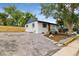 Wide angle of painted brick home with rock yard and a detached garage in back of the property at 5573 S Huron St, Littleton, CO 80120
