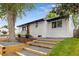 Charming exterior view of home featuring updated landscaping and a freshly painted brick exterior at 5573 S Huron St, Littleton, CO 80120