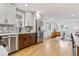 Open concept kitchen showcasing a large island, sleek countertops, and stainless steel appliances, perfect for cooking and entertaining at 5573 S Huron St, Littleton, CO 80120