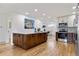 Eat-in kitchen with a large butcherblock island, stainless steel appliances, and a view of the dining room at 5573 S Huron St, Littleton, CO 80120