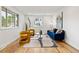 Bright living room with hardwood floors, neutral walls, and modern furniture, perfect for relaxation and entertaining at 5573 S Huron St, Littleton, CO 80120