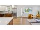 Open living space with hardwood floors featuring kitchen with stainless steel appliances and a modern seating area at 5573 S Huron St, Littleton, CO 80120