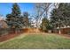 Spacious backyard with grassy area, mature trees, and storage shed at 6631 E Ithaca Pl, Denver, CO 80237