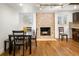 Dining area adjacent to kitchen with hardwood floors and a stone fireplace at 6631 E Ithaca Pl, Denver, CO 80237