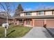 Two-story house with attached two-car garage and landscaping at 6631 E Ithaca Pl, Denver, CO 80237