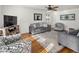 Living room featuring hardwood floors, a ceiling fan, and comfortable seating at 6631 E Ithaca Pl, Denver, CO 80237