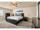 Spacious main bedroom with large bed, dresser, and ceiling fan at 6631 E Ithaca Pl, Denver, CO 80237