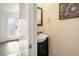 Small powder room with dark vanity and updated fixtures at 6631 E Ithaca Pl, Denver, CO 80237