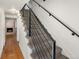 Modern staircase with metal railing and carpet runner at 6631 E Ithaca Pl, Denver, CO 80237