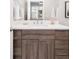 Clean bathroom with wood cabinets and white countertop at 2828 N Federal Blvd, Denver, CO 80211