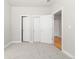 Bedroom with multiple doors and gray carpet at 2828 N Federal Blvd, Denver, CO 80211