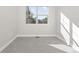 Spacious bedroom with gray carpet and large window at 2828 N Federal Blvd, Denver, CO 80211