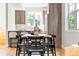 Modern dining area with a long wooden table and black chairs at 2828 N Federal Blvd, Denver, CO 80211