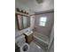 A well-lit bathroom features a vanity, toilet, and shower-tub combination with neutral tile at 475 Tennyson St, Denver, CO 80204