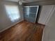 Bedroom with hardwood floors, frosted sliding door closet, neutral walls, and a window at 475 Tennyson St, Denver, CO 80204