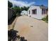 Back of the house and detached garage, connected by a wide driveway and chain-link gate at 475 Tennyson St, Denver, CO 80204
