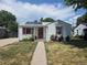 Inviting home with solar panels, garden, pathway, and red window trim at 475 Tennyson St, Denver, CO 80204