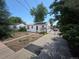 Exterior view of a home with solar panels and a chain-link fence at 475 Tennyson St, Denver, CO 80204