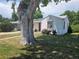 Cozy home with a mature shade tree, well-maintained lawn, and vibrant flowers at 475 Tennyson St, Denver, CO 80204