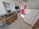 The kitchen features standard appliances, a double sink, and a red door at 475 Tennyson St, Denver, CO 80204