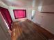 Living room showcasing hardwood flooring, large windows with curtains, and white walls at 475 Tennyson St, Denver, CO 80204