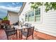 Outdoor patio with a metal table and six matching chairs located off the side of the house with a white exterior at 8721 E 23Rd Ave, Denver, CO 80238