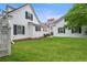 Spacious backyard with a lush green lawn, white fencing, and a patio area perfect for entertaining at 8721 E 23Rd Ave, Denver, CO 80238