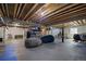 Large unfinished basement with exposed beams and ample space for customization at 8721 E 23Rd Ave, Denver, CO 80238