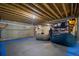 Finished basement with a sports area, large beanbags, exposed wooden ceiling, and an industrial-style steel beam at 8721 E 23Rd Ave, Denver, CO 80238