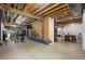 Unfinished basement offers potential with exposed framing and open space for recreation or storage at 8721 E 23Rd Ave, Denver, CO 80238